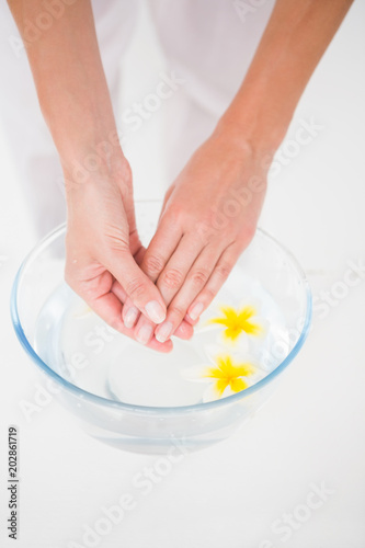 Woman making a hand treatment in a bowl