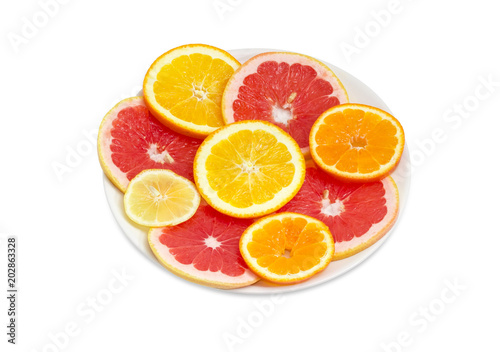 Round slices of the various citrus on a white dish