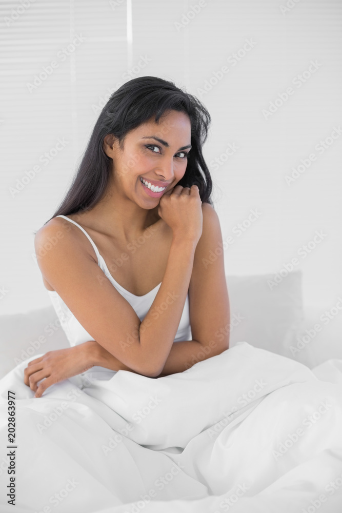 Beautiful young woman smiling cheerfully at camera 