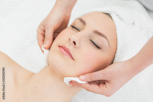 Hands massaging a beautiful womans face