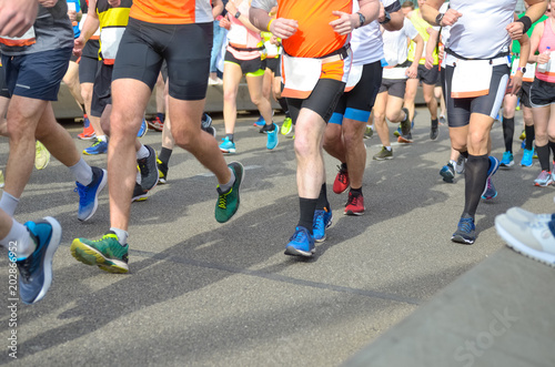 Marathon running race, many runners feet on road racing, sport competition, fitness and healthy lifestyle concept 