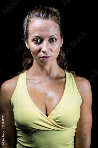 Portrait of confident bodybuilder in yellow sportswear