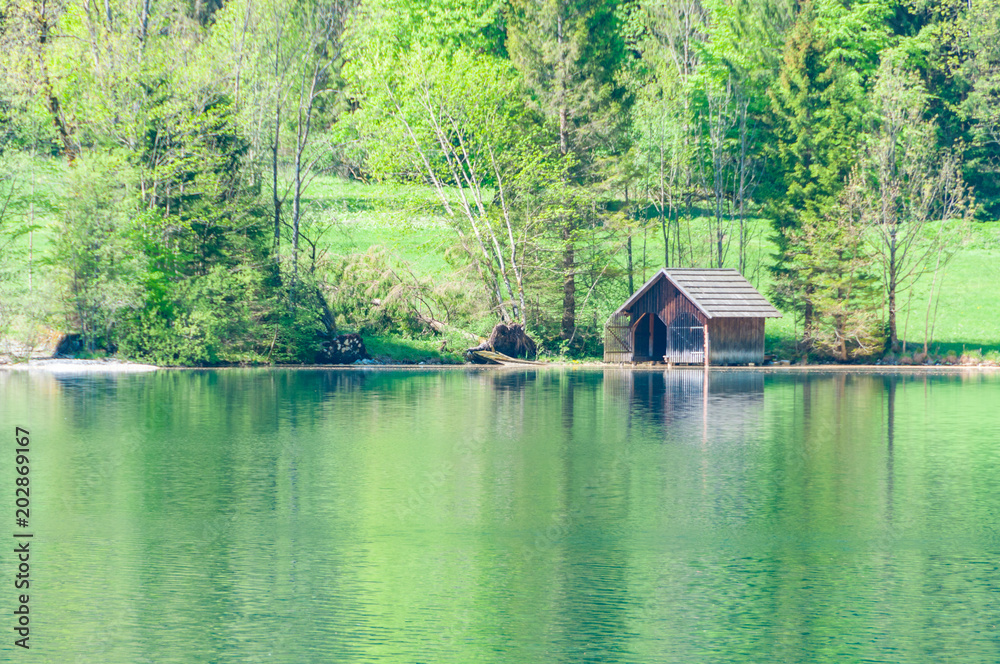 Fototapeta premium old boat house with calm lake and reflection