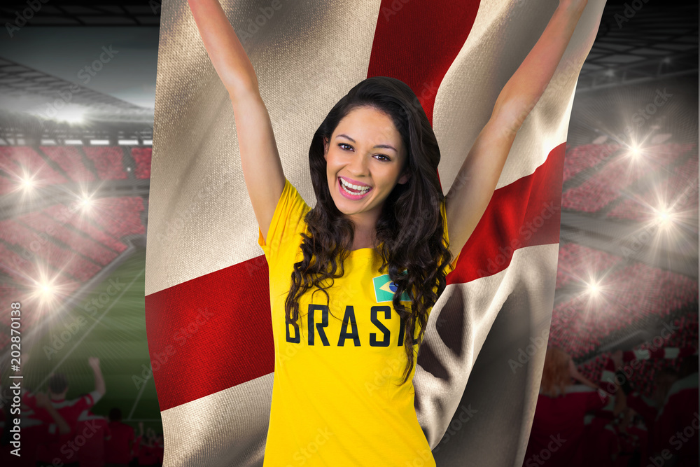 Φωτογραφία Excited football fan in brasil tshirt holding england flag against vast football