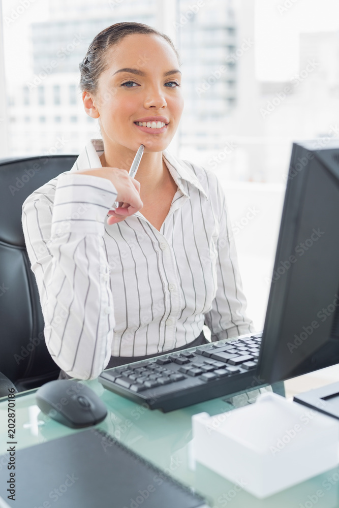 Attractive businesswoman sitting at her desk Attractive businesswoman sitting at her desk