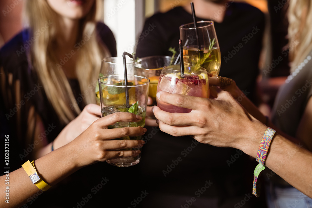 Close up of friends toasting drinks