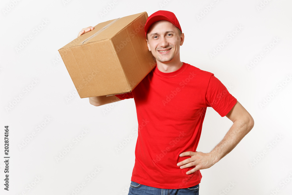 Delivery young man in red uniform isolated on white background. Male in cap, t-shirt, jeans working as courier or dealer holding empty cardboard box. Receiving package. Copy space for advertisement. Delivery young man in red uniform isolated on white background. Male in cap, t-shirt, jeans working as courier or dealer holding empty cardboard box. Receiving package. Copy space for advertisement.