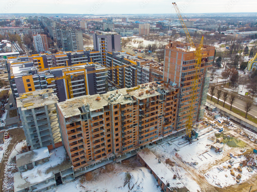 Fototapeta premium birds eye view on contraction site with crane