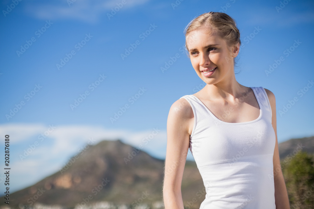 Blonde woman in front of mountain