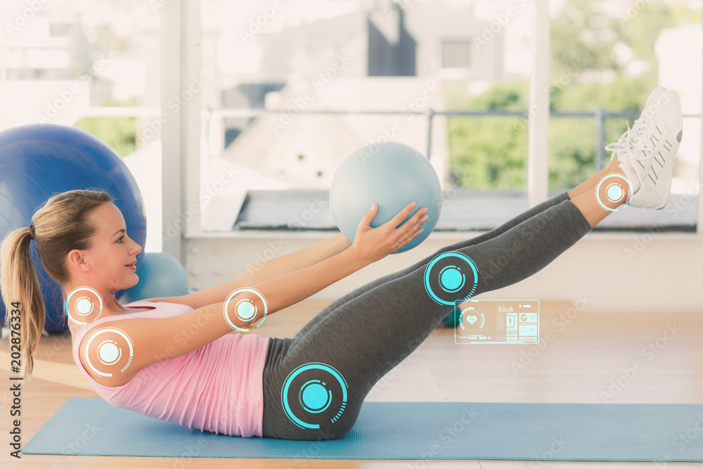 Φωτογραφία Sporty young woman stretching body in fitness studio against fitness interface