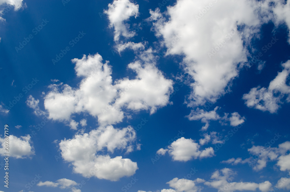 Blue sky with white clouds in sun rays Blue sky with white clouds in sun rays