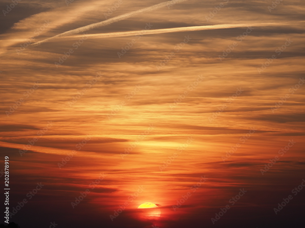 Spectacular colorful sky at sun set with clouds formation seen in spring evening from european city in Poland