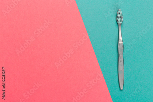 Toothbrush on a bright bicolor background, top view