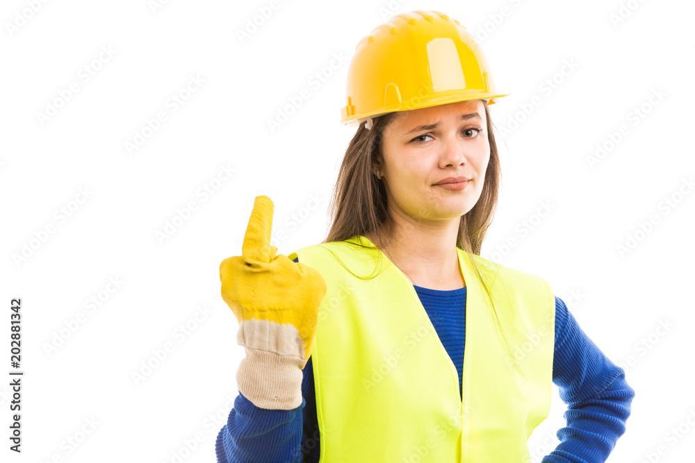 Young female constructor showing fuck you sign. Young female constructor showing fuck you sign.