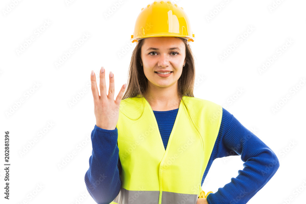 Young woman engineer showing number four. Young woman engineer showing number four.