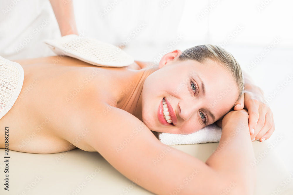 Peaceful blonde enjoying an exfoliating back massage Peaceful blonde enjoying an exfoliating back massage