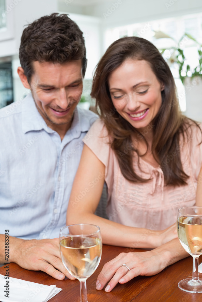 Couple with wine glasses at dining table