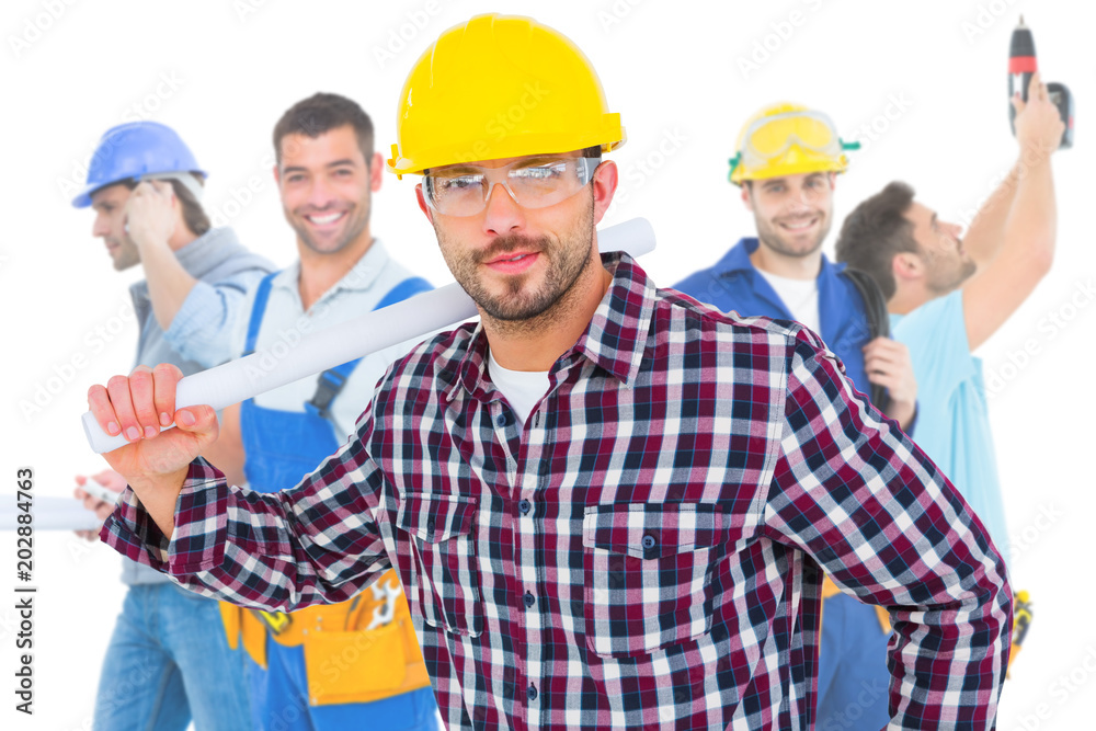 Composite image of handyman holding rolled up blueprint Composite image of handyman holding rolled up blueprint