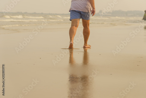 Man walking alone on the beach. beach travel at summer time concept © bigy9950