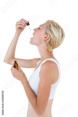 Принти на полотні Fit blonde woman swallowing medicine