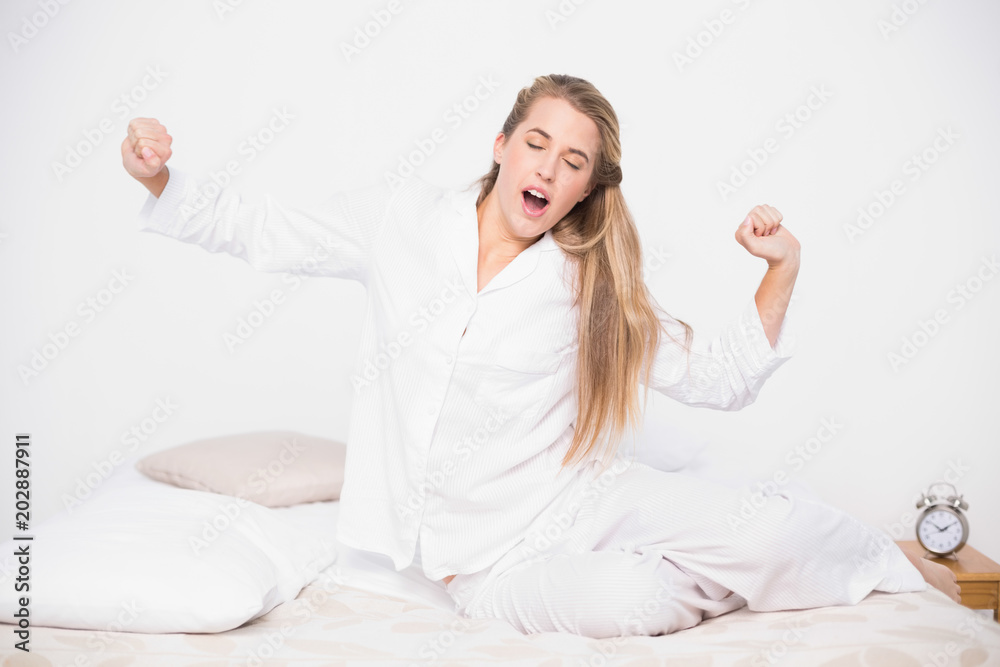 Yawning pretty model stretching in cosy bed Yawning pretty model stretching in cosy bed