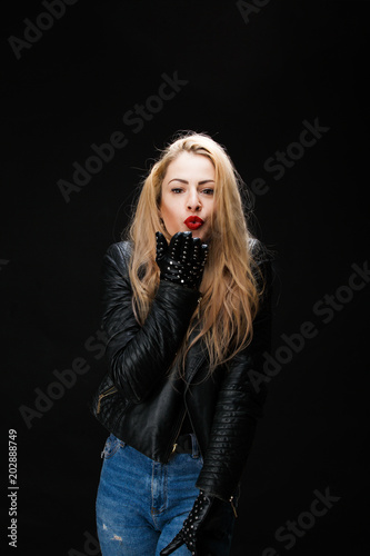 Photo of young blonde in leather jacket sending air kiss