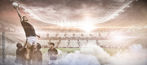 Digital composite image of stadium against rugby players jumping for line out