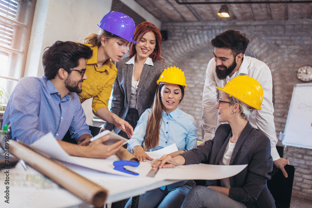 Meeting the team of engineers working on a construction project at the table Meeting the team of engineers working on a construction project at the table