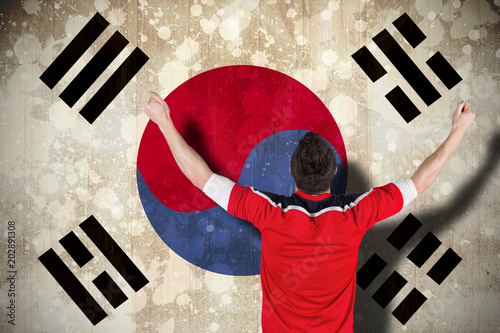 Excited football fan cheering against south korea flag