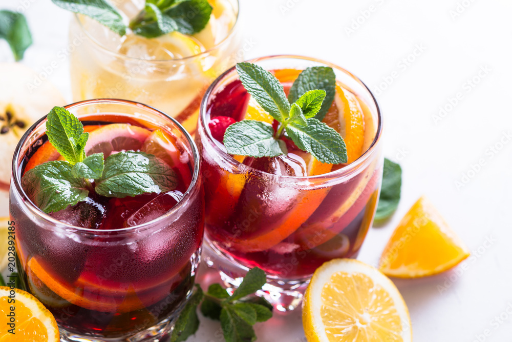 White, pink and red sangria with fruit, ice and mint. White, pink and red sangria with fruit, ice and mint.