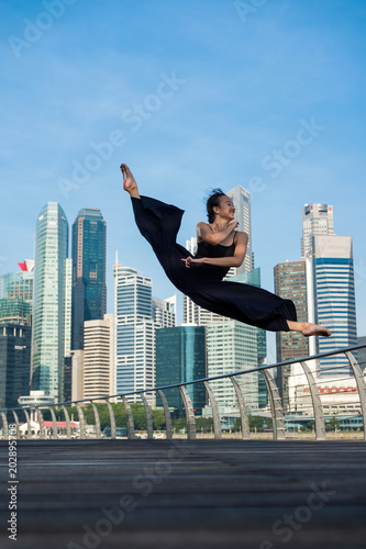 Elegant ballet dancer woman dancing ballet in the city