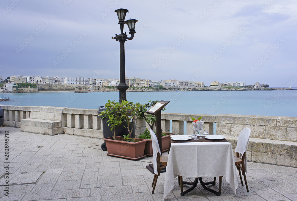 Φωτογραφία Italy, Puglia, Otranto, restaurant at the bay, referred to as the road of Otrant