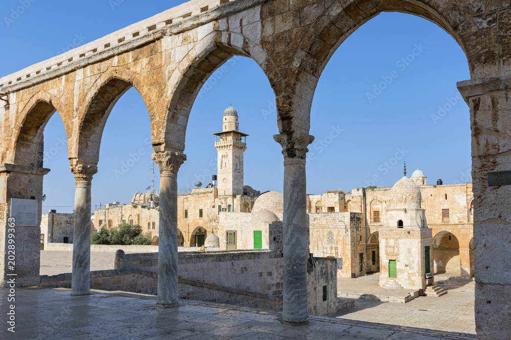 The minaret of a mosque in Old Jerusalem seen through an arch on the Haram es Sharif also known as the Temple Mount, Israel.
