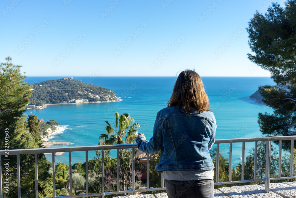 Woman looking at the seascape from the top