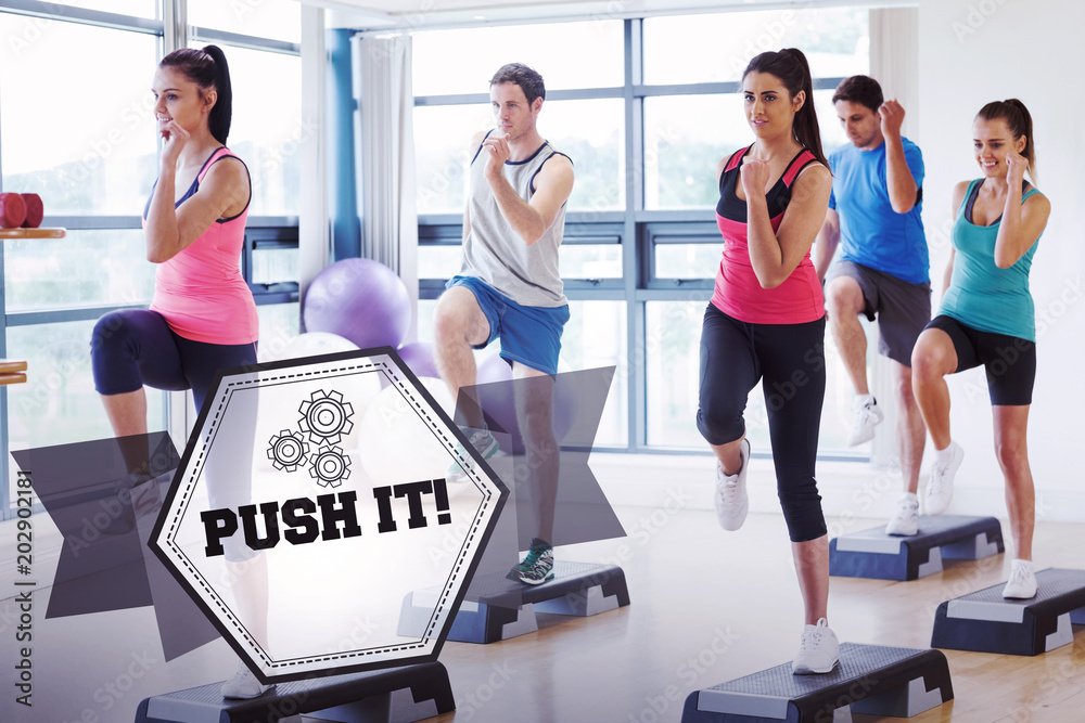 The word push it! and instructor with fitness class performing step aerobics exercise against hexagon The word push it! and instructor with fitness class performing step aerobics exercise against hexagon