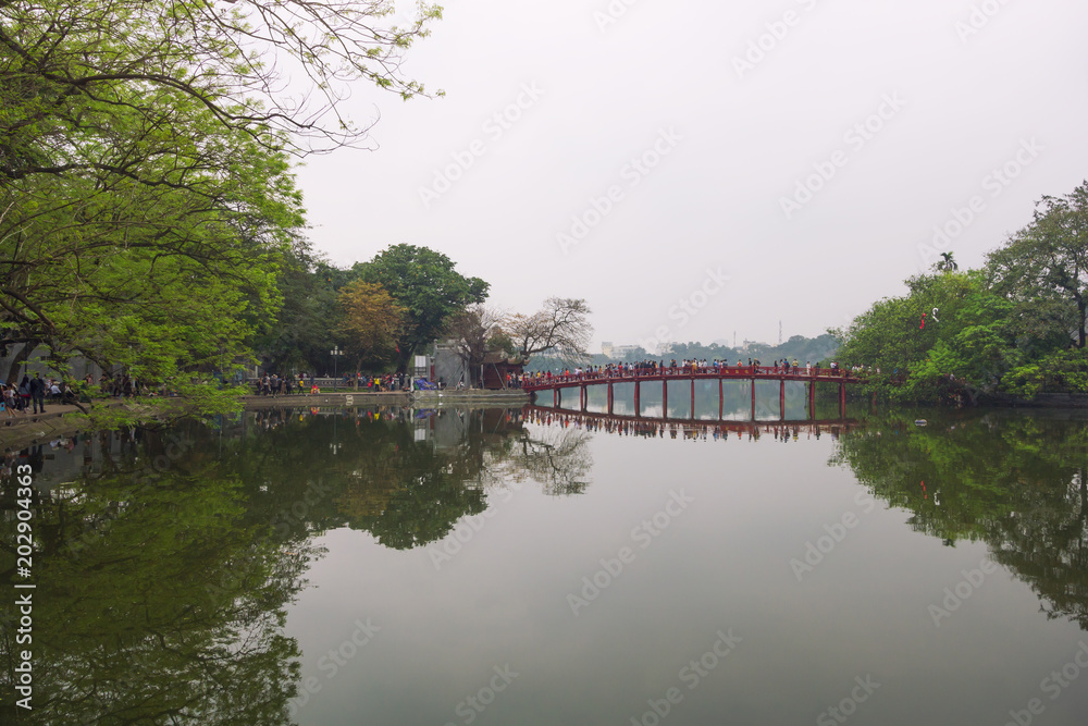 Beautiful view of the Huc Bridge leads to Ngoc Son Temple on a small island (Original built in 1841), Hoan Kiem Lake, Hanoi, Vietnam