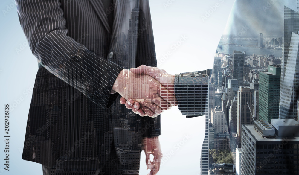 Φωτογραφία Business people shaking hands against city skyline