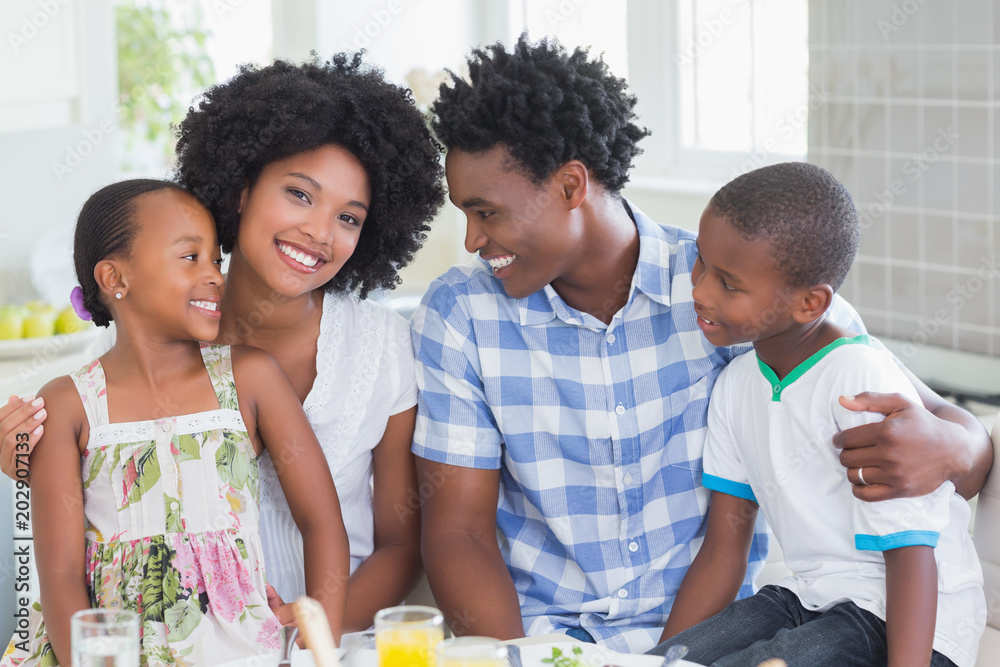 Happy family sitting down to dinner together Happy family sitting down to dinner together
