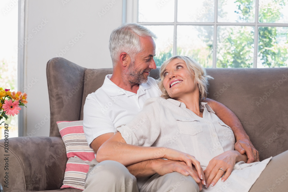 Relaxed mature couple sitting on couch Relaxed mature couple sitting on couch