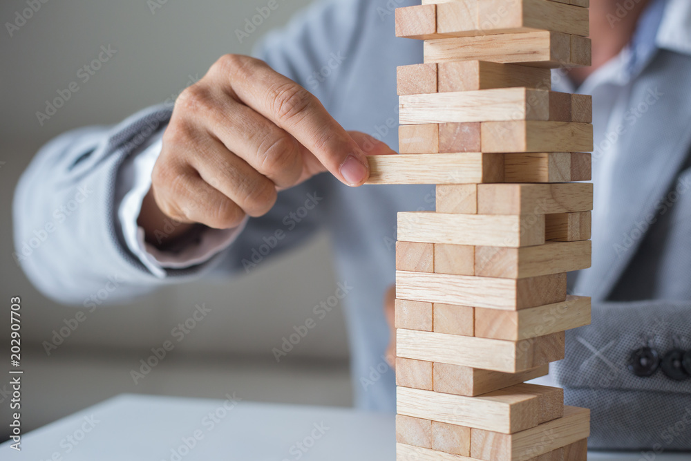 Φωτογραφία Planning, risk and strategy in business, businessman and engineer gambling placing wooden block on a tower