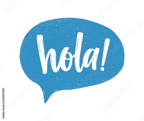 Hola Spanish greeting handwritten with white calligraphic cursive font inside blue speech bubble or balloon. Creative hand lettering. Modern vector illustration for t-shirt, tee or sweatshirt print. photo