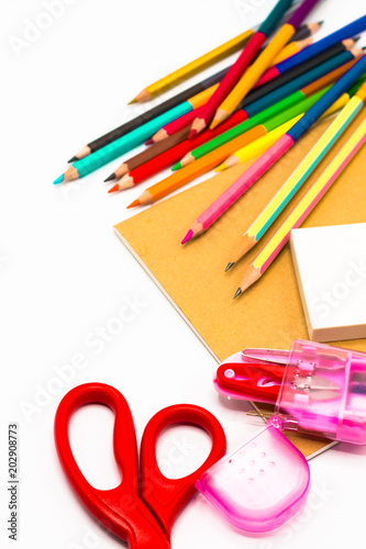 Books ,pen,pencil,Scissors and office equipment on board background, education and back to school concept,Clipping path