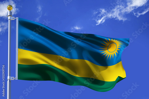 The silk waving flag of Rwanda with a flagpole on a blue sky background with clouds .3D illustration.. photo