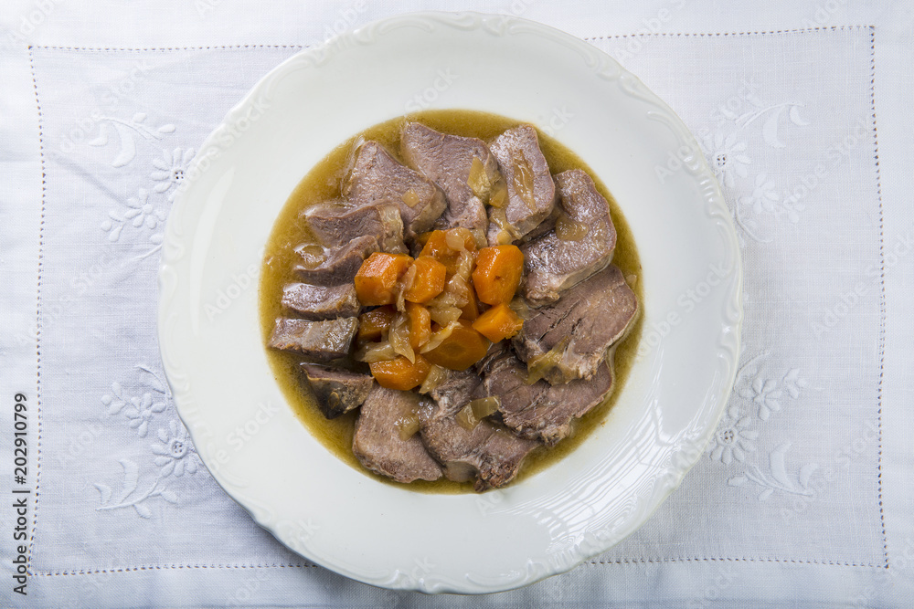 Lengua De Cerdo Estofada Con Zanahorias Y Cebolla Stock Photo Adobe Stock