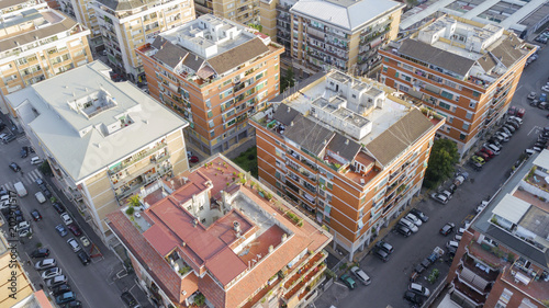 Aerial view of the Magliana district in Rome. There are many buildings with balconies and windows between the streets of the district. This is a residential area of the Italian capital