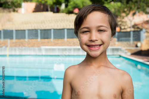 Smiling boy standing near poolside