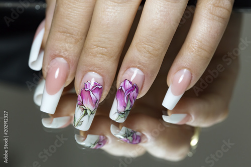 Beautiful multicolored flowers on a transparent lacquer on the nails