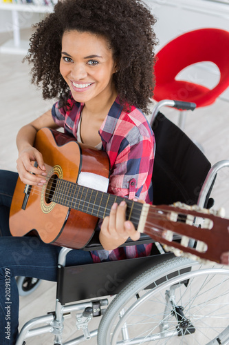 young female musican on wheelchair photo