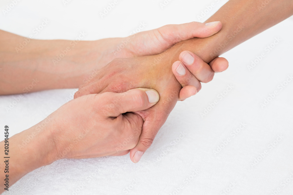 Fototapeta premium Doctor examining a female patients hand