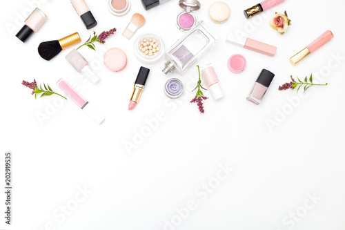 Make up products and flowers on white background. Copy space